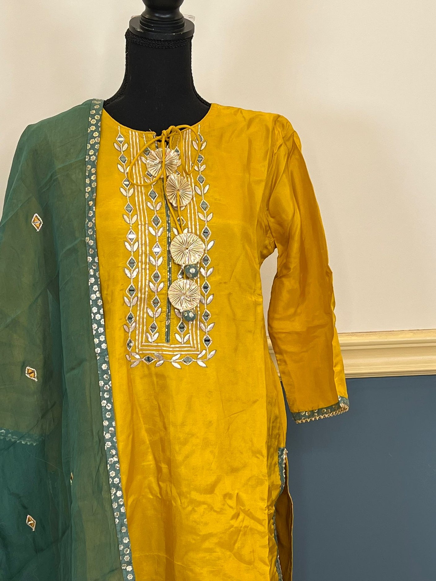 Pure russian silk with beautiful Patra mirror,gotta patti and resham embroidery on neck with tuscons ,gotta lace on ghera and sleeves, pure organza duppta with beautiful gotta patti and mirror handwork embroidery on duppta with print border