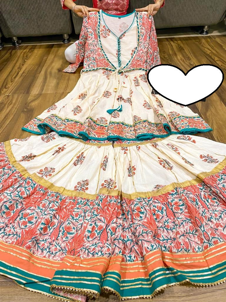 Premium cotton peplum with attached jacket detailed with pipe work , tassles & gota work.